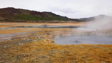 Steam of evaporating Sulphur coming out of bubbling mud pods field in Northern Iceland