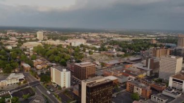 Drone footage of financial and administrative offices in downtown district of Lexington, Kentucky with campus and buildings of University of Kentucky visible on the distance