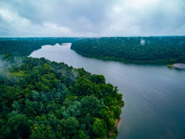 Curves of a long and tight lake in Central Kentucky between banks covered in forest