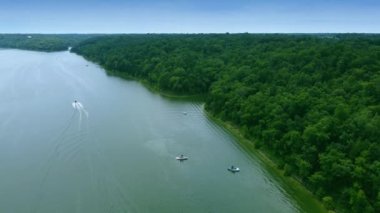 Following a speed boat sailing between various recreational nautical vessels in Taylorsville lake in Central Kentucky