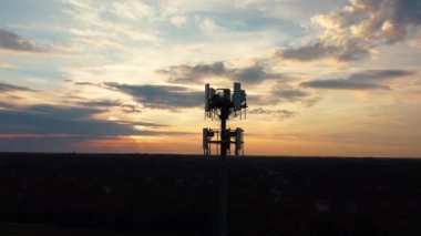 Aerial silhouette of circling around Cell phone retranslation tower during early morning hours showing still slipping neighborhoods of the mid western city of Lexington, Kentucky