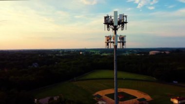 5G cell phone tower on a hill in a park surrounded by neighborhoods of mid west American city