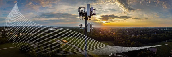 Graphical representation of a mesh of radio waves in front of cell phone tower during dramatic sunrise
