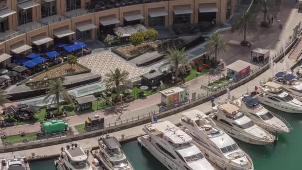 Dubai marina promenade on waterfront along canal aerial timelapse. — Stock Video