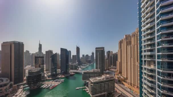 Luchtfoto naar Dubai jachthaven wolkenkrabbers rond kanaal met drijvende boten de hele dag timelapse — Stockvideo