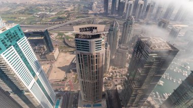 JLT bölgesindeki gökdelenleri sis kapladı. Akşam saatlerinde Dubai marina kulelerinden golf sahası ve karayolu trafiği olan en iyi manzara.