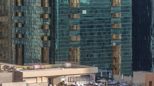 豪華な屋外屋上スイミングプールと空中のタイムラプスの周りのリラックスしたゾーン 高層ビルが立ち並ぶトップビュー ドバイ — ストック写真