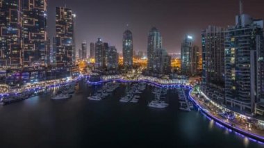 Dubai marinasında gece boyu şehir havasında lüks yat hangarı.