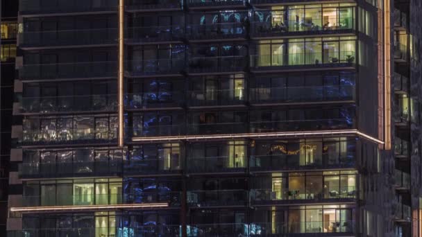 Flat night panorama of multicolor light in windows of multistory buildings aerial timelapse. — Stock Video