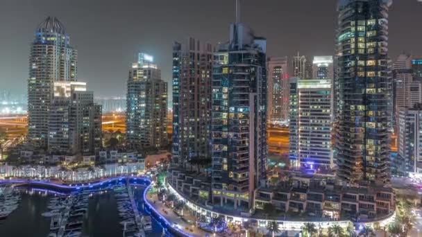 Dubai Marina luxe toeristische wijk met wolkenkrabbers en torens rond kanaal antenne nacht timelapse — Stockvideo