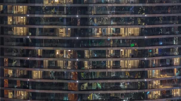 Outside view of windows in apartments of a high class building at night timelapse — 图库视频影像