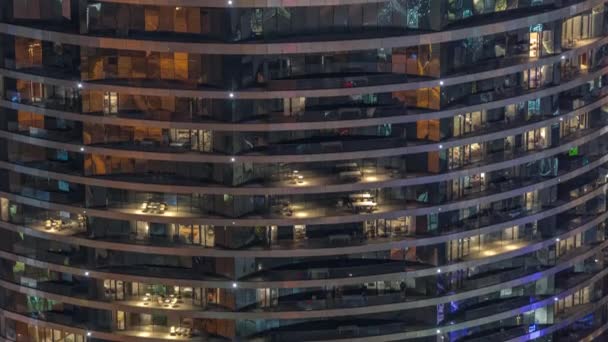 Outside view of windows in apartments of a high class building at night timelapse — Vídeo de Stock