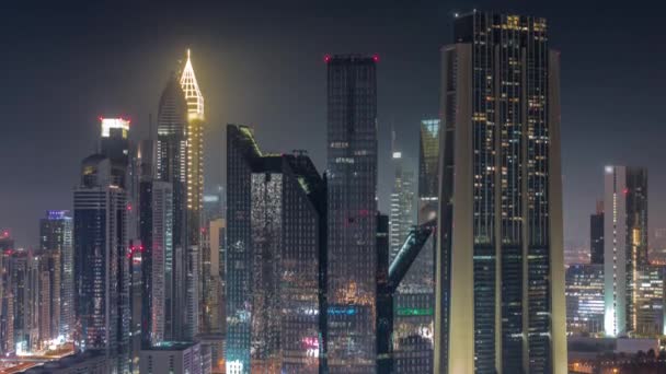 Close up view of Dubai Financial Center district with tall skyscrapers illuminated all night timelapse. — 图库视频影像