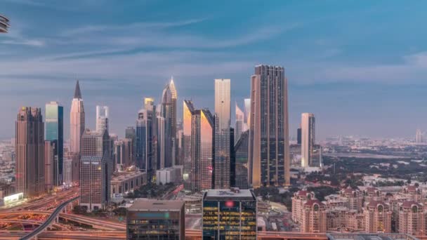 Panorama of Dubai Financial Center district with tall skyscrapers with illumination day to night timelapse. — Stock Video