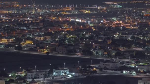 Aerial view of many apartment houses and villas in Dubai city night timelapse from skyscraper in downtown — Stockvideo