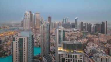 Aerial view of a big futuristic city day to night timelapse. Business bay and Downtown