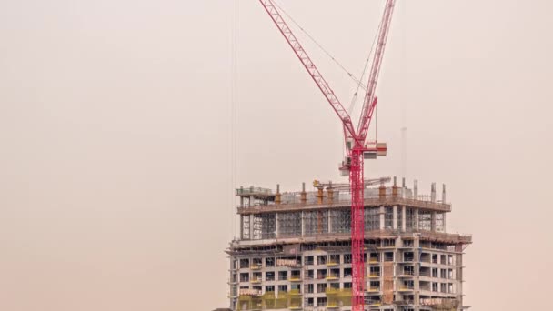 Tall buildings under construction and cranes timelapse — Wideo stockowe