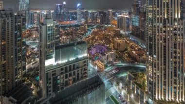 Aerial panoramic view of a big futuristic city night timelapse. Business bay and Downtown