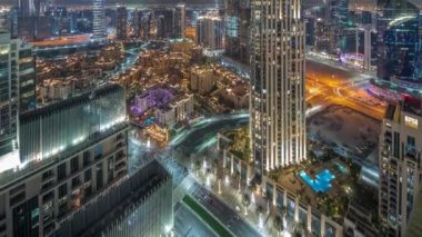 Aerial panoramic view of a big futuristic city night timelapse. Business bay and Downtown