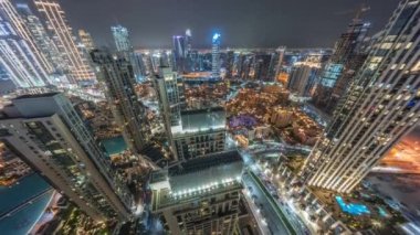 Aerial panoramic look down view of a big futuristic city night timelapse. Business bay and Downtown