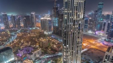 Aerial panoramic view of a big futuristic city night timelapse. Business bay and Downtown