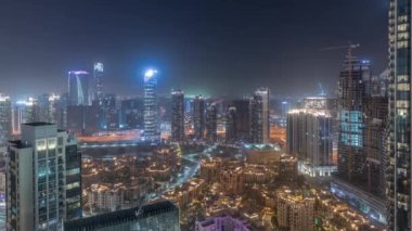 Aerial panoramic view of a big futuristic city night timelapse. Business bay and Downtown