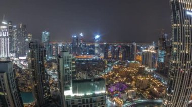 Aerial panoramic view of a big futuristic city all night timelapse. Business bay and Downtown
