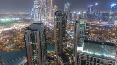 Aerial panoramic view of a big futuristic city night timelapse. Business bay and Downtown
