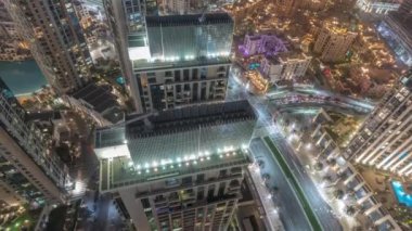 Aerial look down view of a big futuristic city night timelapse. Business bay and Downtown