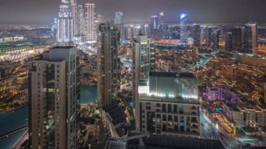 Panorama showing aerial view of a big futuristic city night timelapse. Business bay and Downtown