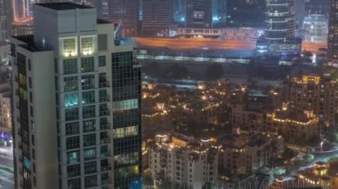 Aerial view of a big futuristic city night timelapse. Business bay and Downtown