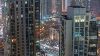 Aerial panoramic view of a big futuristic city night timelapse. Business bay and Downtown