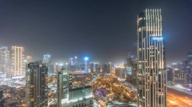 Aerial panoramic view of a big futuristic city night timelapse. Business bay and Downtown
