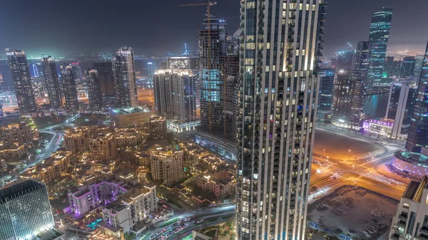 ビジネスベイとダウンタウン地区の空中パノラマビュー 多くの高層ビルや伝統的な家 ドバイ アラブ首長国連邦のスカイラインで大きな未来的な都市の夜のタイムラプス — ストック写真