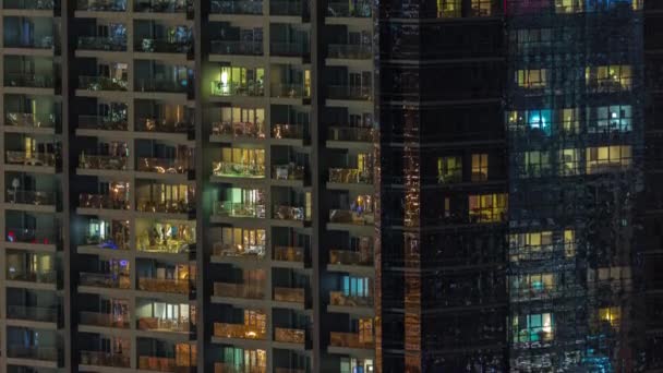 Windows of apartment building at night timelapse, the light from illuminated rooms of houses — Stock Video