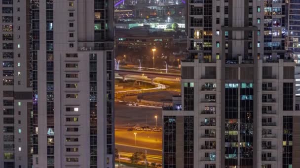 Den andra gångbron över Dubais vattenkanal, upphängd av en oval båge, timelapse på natten från Business Bay-distriktet. — Stockvideo