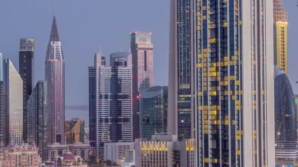 Σειρά των ψηλών κτιρίων γύρω από Sheikh Zayed Road και DIFC περιοχή εναέρια νύχτα έως την ημέρα timelapse στο Ντουμπάι — Αρχείο Βίντεο