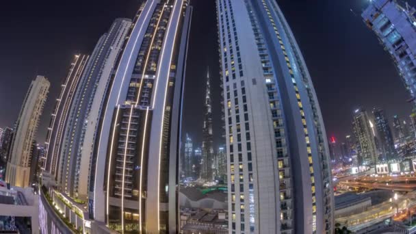 Tallest skyscrapers in downtown dubai located on bouleward street near shopping mall aerial night timelapse. — Stock Video