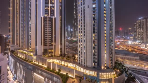 Tallest skyscrapers in downtown dubai located on bouleward street near shopping mall aerial night timelapse. — Stock Video