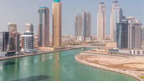 Cityscape skyscrapers of Dubai Business Bay with water canal aerial timelapse. — Stock Video