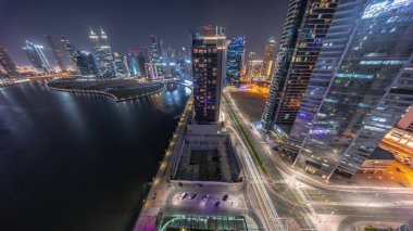 Dubai İş Körfezi 'ndeki gökdelenlerin şehri. Panoramik manzaraya bakan su kanalları gece saatleri. Aydınlatılmış kuleleri ve rıhtımı olan modern gökyüzü. Uluslararası bir iş merkezi.