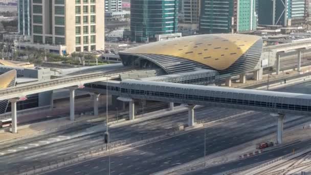 Aerial view of Metro station near Jumeirah lakes towers skyscrapers timelapse with traffic on sheikh zayed road. — Stock Video