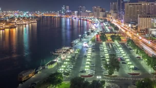 Dubai Creek landscape night timelapse with boats and ship near waterfront — стоковое видео