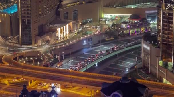 Bussy traffic on the overpass intersection in Dubai downtown aerial night timelapse. — Stock Video