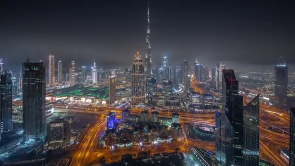 Aerial view of tallest towers in Dubai Downtown skyline and highway night timelapse. — Stock Video