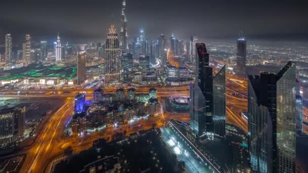 Aerial view of tallest towers in Dubai Downtown skyline and highway night timelapse. — Stock Video