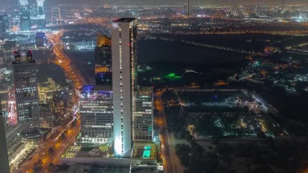 Wolkenkrabbers en andere gebouwen in de buurt van het Dubai World Trade Center district in Dubai luchtfoto nachtelijke tijdspanne — Stockvideo