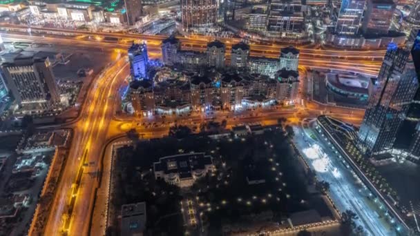 Bussy traffic on the roads and intersection in Dubai downtown aerial night timelapse. — Stock Video