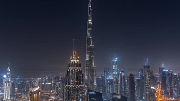 Aerial view of tallest towers in Dubai Downtown skyline and highway night timelapse. — Stock Video
