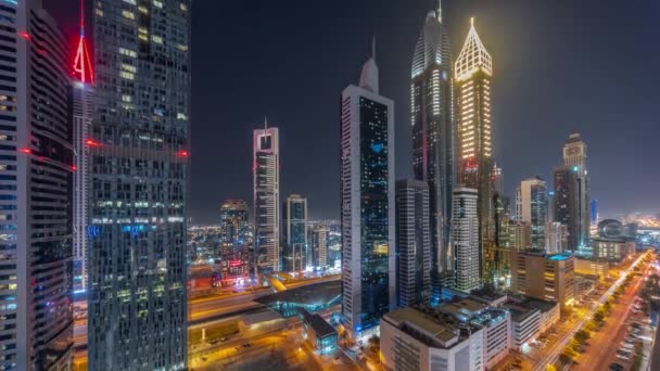 Aerial view of Dubai International Financial District with many skyscrapers all night timelapse. — Stock Video